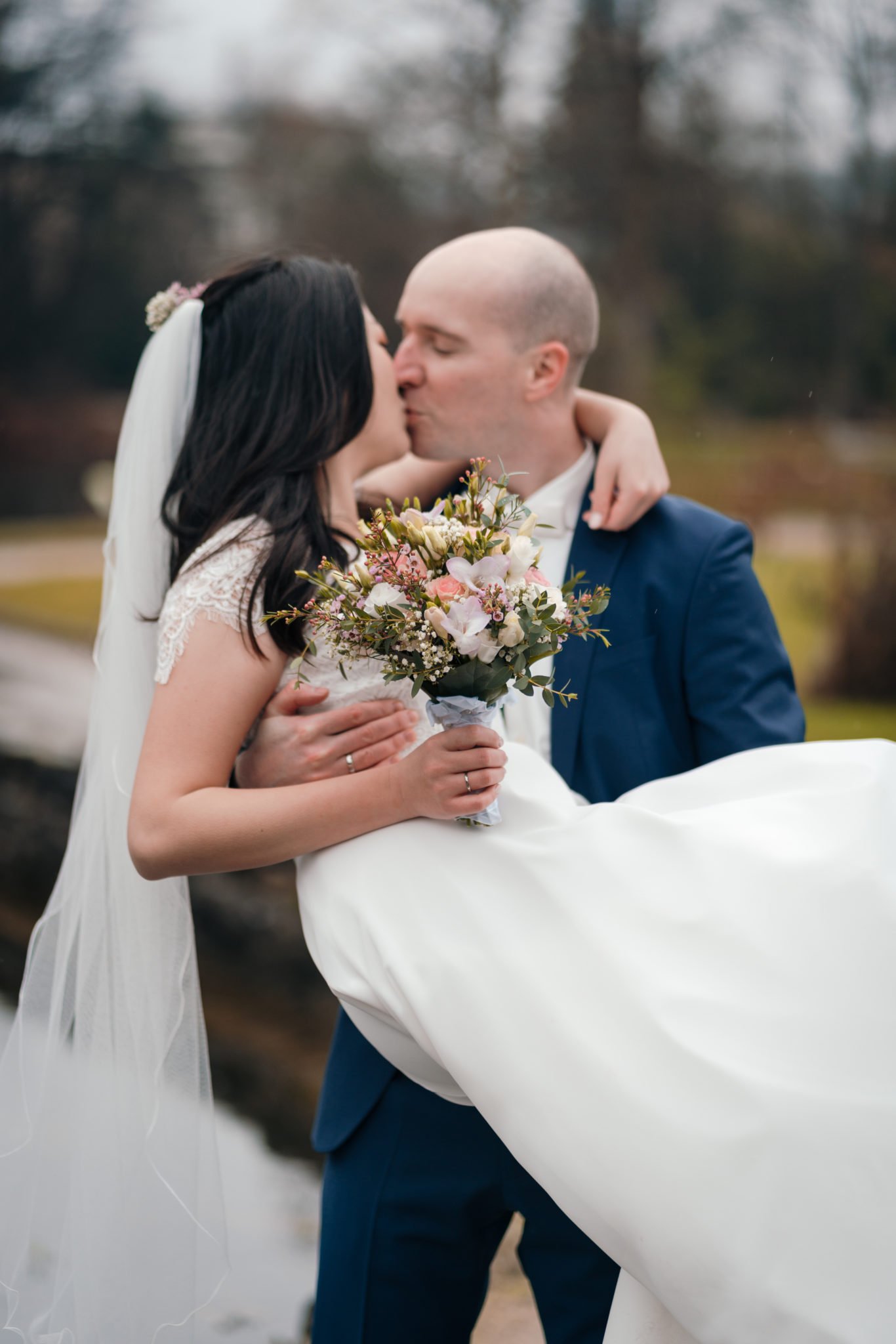 Bräutigam hebt sein Braut hoch und küsst sie