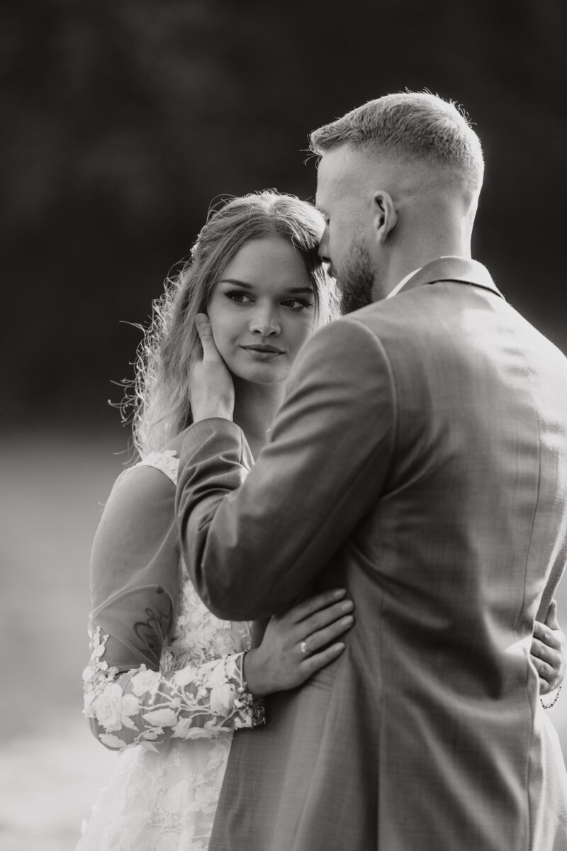 After Wedding Portfolio, Braut und Bräutigam halten sich in den Armen, Foto in schwarz-weiß