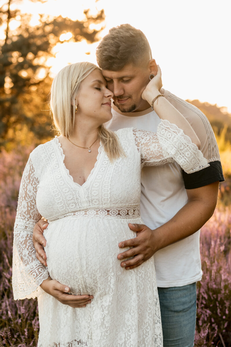 Babybauch Fotografie Portfolio verliebtes Paar posiert in der Natur