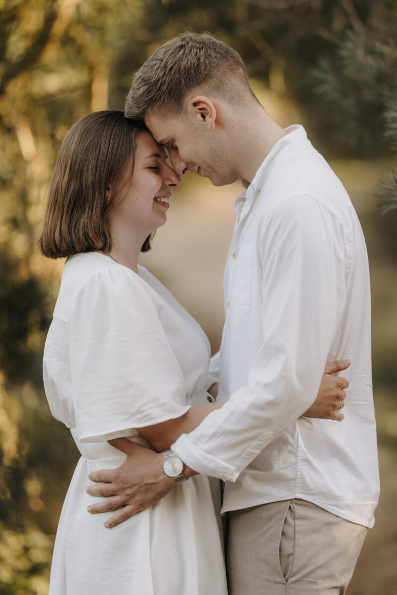 Paar umarmt sich Stirn an Stirn in der Abendsonne