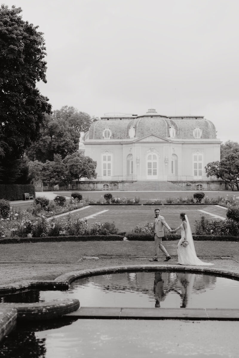 Hochzeitsportfolio, Schwarzweißaufnahme eines Brautpaares vor einem Schlossgarten | Hochzeitsfotografin NRW